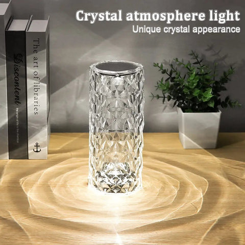 Crystal Diamond Night Light Lamp With 16 RGB Colors And 4 Modes on wooden table next to books and plant.