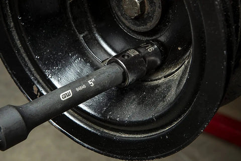 44 Piece 1/2 Inch Drive Impact Socket Set With Standard And Deep SAE/MM Sockets in use on automotive wheel, black oxide finish