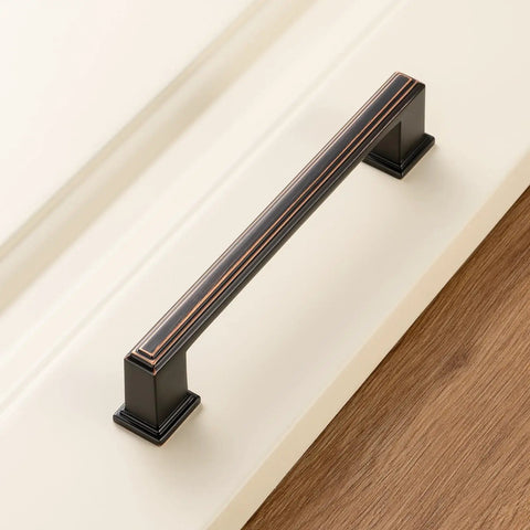 Stepped Bar Cabinet Pull in Oil Rubbed Bronze, 5 Inch Screw Spacing on white cabinet surface