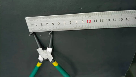4 Piece Snap Ring Pliers Set With 7 Inch Round Nose C Clamps next to a measuring ruler, showing durable steel construction.