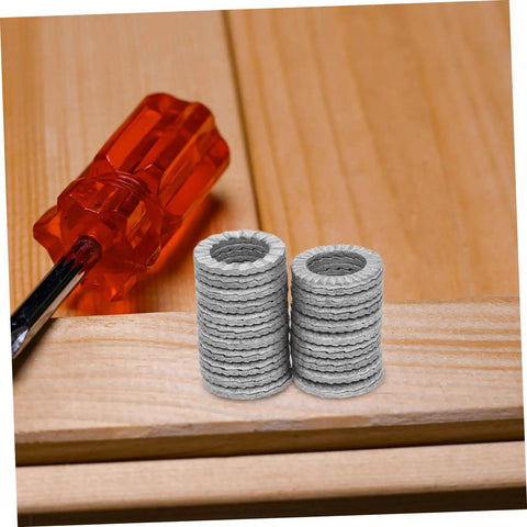 Premium 20 Piece Manganese Lock Washers With Double Wedge Tooth Design stacked on wood next to a screwdriver.