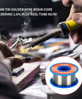 Person using a 60W Soldering Iron Kit with Ceramic Heater for electronics DIY and hobby projects, with a tin solder wire shown.