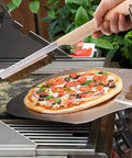 21 Inch Pizza Oven Brush With Scraper Copper Wire Cleaning Brush With Brass Bristles in use on a BBQ grill with pizza