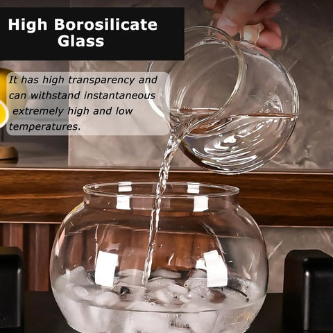 Pouring water from a glass vessel into a large glass bowl with ice, showcasing the Large Capacity Cold Brew Coffee Maker Tower.