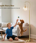 Boy playing with dog near Gold Modern Floor Lamp With Globe Glass Shade, 68 Inch Tall Mid Century Standing Lamp For Living Room And Bedroom