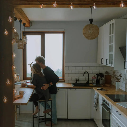 Cozy kitchen with Indoor 2 Pack G50 LED String Lights with Vintage Filament Bulbs, shatterproof design, enhancing atmosphere.