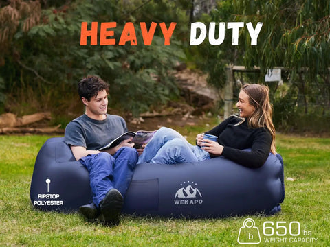 Couple relaxing on inflatable couch air lounger chair no pump needed for camping and beach trips, durable ripstop polyester in lawn.