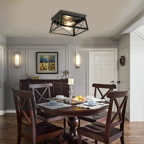Two Light Flush Mount Ceiling Light Fixture In Matte Black With Open Cage Metal Frame in a dining room setting.