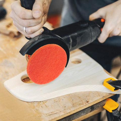 10 Pcs Orange Nylon Hook And Loop Electric Sanding Discs 2000 Grit for polishing wood with a power sander on a workbench.