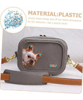 Front view of gray faux-leather mini crossbody bag with blue studs, dog-face patch, gold hardware, brown strap.