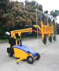 Heavy Duty Electric Glass Vacuum Lifter with suction cups lifting a large glass panel outdoors, designed for facade installations.