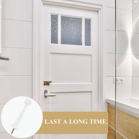 Heavy Duty Floor Door Stopper With Soft Rubber Tip And Zinc Alloy next to a white bathroom door showing its durability