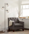 Modern Three Light Floor Lamp With Adjustable Ribbed Glass Shades And Reading Light, 68 Inches Tall against a white wall