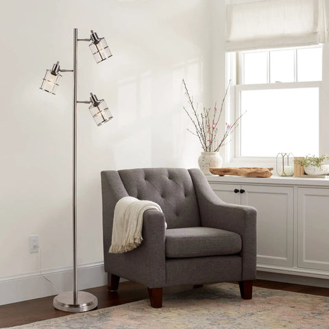 Modern Three Light Floor Lamp With Adjustable Ribbed Glass Shades And Reading Light, 68 Inches Tall against a white wall