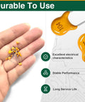 Hand holding ceramic capacitors, close-up of Ceramic Capacitor Kit 350 Pieces With Ten Values From 100nF To 10uF 50V MLCC.