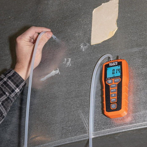 Front view of orange Klein Tools ET180 digital manometer with dual ports and backlit LCD.
