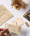 Adult 3D Wooden Jigsaw Puzzle Kit with airship model parts and assembly instructions on a desk.