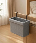 Gray hanging storage basket with dual steel hooks attached to bed for small garments organization.