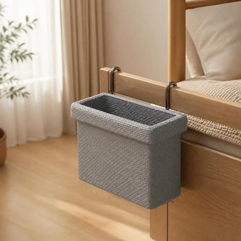 Gray hanging storage basket with dual steel hooks attached to bed for small garments organization.