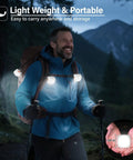 Man hiking with backpack wearing Rechargeable Tent Lights 2 Pack Portable LED Camping Lanterns With 510 Lumens Bright White Beam.