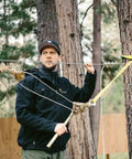 Man using Zip Line Tensioning Kit with Beefy 2 Ton Ratchet Winch, Cable Grab for Three Sixteenths to Three Quarters Inch Cable on trees.