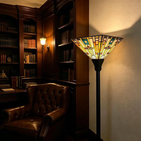70 Inch Tiffany Torchiere Floor Lamp With Antique Mission Style Stained Glass Shade in a cozy library setting, amber glow