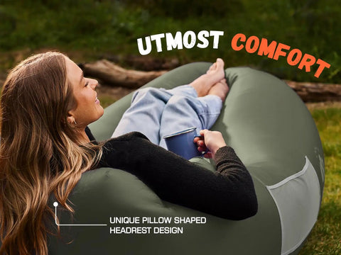 Person relaxing on olive green Inflatable Lounger Couch Portable Air Sofa Chair For Camping Beach Hiking Lawn Backyard And Outdoor Festivals Pump Free No Pump Needed Air Hammock With Airtight Seal And Cozy Pillow Shaped Headrest For Chill Vibes