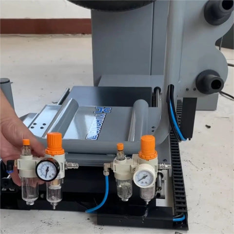 Pro Grade Tire Changer Air Compressor Regulator Kit installed on machine base, showing pressure gauge and quick connectors