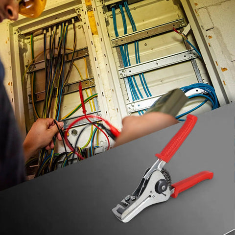 Heavy Duty Automatic Wire Stripper Pliers With Integrated Adjustable Ruler For 0.5 To 4.0mm Cables in use, stripping wires in an electrical panel.
