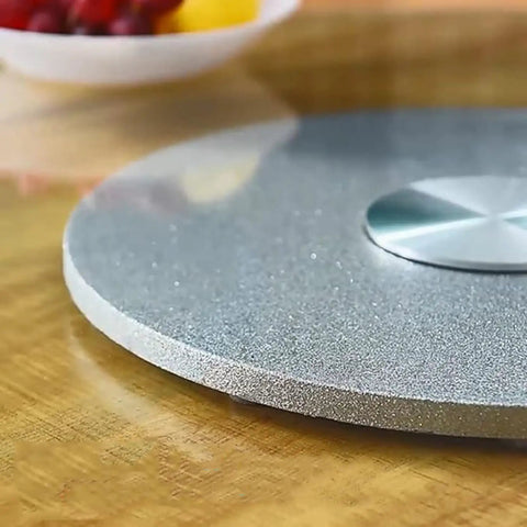 Top Shelf Heavy Duty Tempered Glass Lazy Susan Turntable close-up on wooden table, showcasing smooth surface and stainless steel bearing.