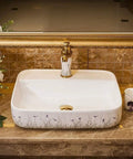 Ceramic Vessel Sink For Bathroom Vanity, Above Counter Rectangular Wash Basin Featuring Hand Painted Nordic Artistry, Slick Glossy Finish And Fresh Contemporary Style That Pops In Any Space on marble countertop.