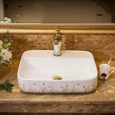 Ceramic Vessel Sink For Bathroom Vanity, Above Counter Rectangular Wash Basin Featuring Hand Painted Nordic Artistry, Slick Glossy Finish And Fresh Contemporary Style That Pops In Any Space on marble countertop.