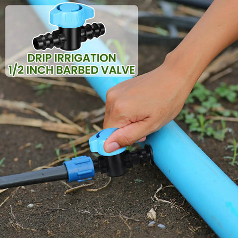 Hand adjusting 12 Pack One-Half Inch Drip Irrigation Barbed Valve Fittings With Ball Shut Off Barbed Switch Valves on blue tubing