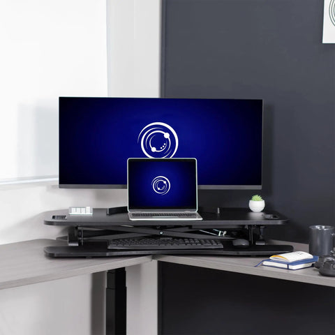 Extra Wide 38 Inch Corner Desk Converter With Height Adjustable Sit To Stand Riser for Dual Monitor and Laptop Setup in office.