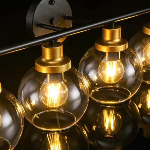 Close-up of 4 Light Vintage Style Bathroom Vanity Light Fixture With Clear Globe Glass Shades, Black And Brass Gold Accents