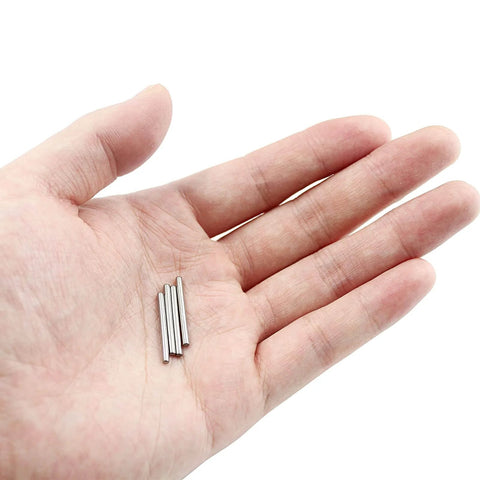 Hand holding three 100 Pcs Stainless Steel Shelf Dowel Pins 2mm By 22mm For Cabinet And Furniture Replacement Hardware.