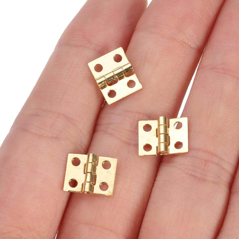 100 Pcs Mini Brass Hinges For Cabinets And DIY Projects, gold finish small butt hinges 0.4 by 0.3 inch, shown on hand