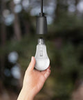 Hand holding A19 LED Motion Sensor Bulb With 60W Equivalent, 5CCT Options, E26 Base, 800 Lumens, Auto On Auto Off, Smart Energy Saving Lighting For Hallways And Rooms In Any Home.
