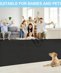 Family and a dog behind a 120 Inch Extra Wide Retractable Baby Gate For Large Openings Perfect For Doorways And Indoor Outdoor Use Ultra Long Mesh Pet Gate For Dogs And Puppies Wall Baseboard Friendly Easy Install Black.