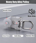 Heavy Duty Ceiling Curtain Track System With Smooth Silent Pulleys And Double Aluminum Runners Paired With A Slick Cornice Cover For Total Blackout And Effortless Home Setup close-up of heavy duty alloy pulley with smooth design and stainless steel parts.