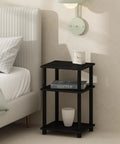 3 Tier Open Storage Nightstand With Turn N Tube Poles next to bed, Sleek Americano Black Bedside Table with lamp and books displayed