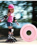 Child skating on inline skates with pink protective gear beside Inline Skates Replacement Wheels Pack 4 Or 8 72mm 76mm 80mm 86A Hardness
