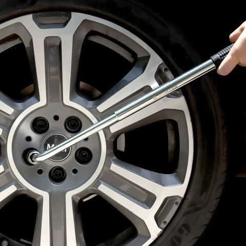 Telescoping 4 Way Lug Wrench Extendable Half Inch Drive With 17 19mm And 21 23mm Sockets in use on car wheel lug nut