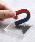 Hand holding U-shape magnet with iron filings in Magnetism Science Kit for Kids and Teens Hands On Physics Experiments STEM Education Toy Set