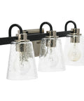 Three Light Vanity Fixture With Seeded Glass Diffusers Matte Black Finish With Polished Nickel Accents Sleek Industrial Vibe