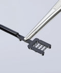 Precision Tweezers With Approx 30 mm Round Tips And Fine Serration, Nickel Plated Chrome Finish holding small electronic component
