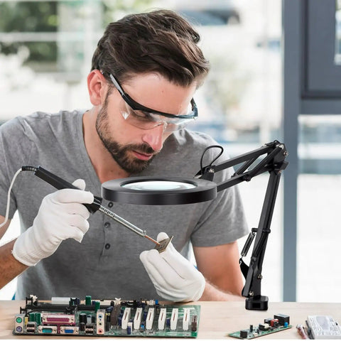 Man using LED Magnifier Desk Lamp With Stand And Clamp Three Color Modes And Stepless Dimming 5 Diopter Real Glass Lens Adjustable Swivel Arm for electronics repair