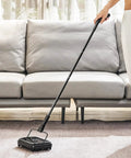 No Strings Attached Manual Carpet Sweeper For Hardwood Floors Tile And Area Rugs Zero Cords Or Batteries Needed Just Brisk Sweep Motion in use on area rug.