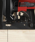 Close-up of Heavy Hitter 13 Amp 7 1/4 Inch Corded Circular Saw showing cutting guide and blade on wood. Precision tool for clean cuts.