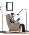 Man reading in chair next to 5X Rechargeable Floor Magnifying Glass With Light And Stand 43 LED Handy Hands Free Magnifier Lamp